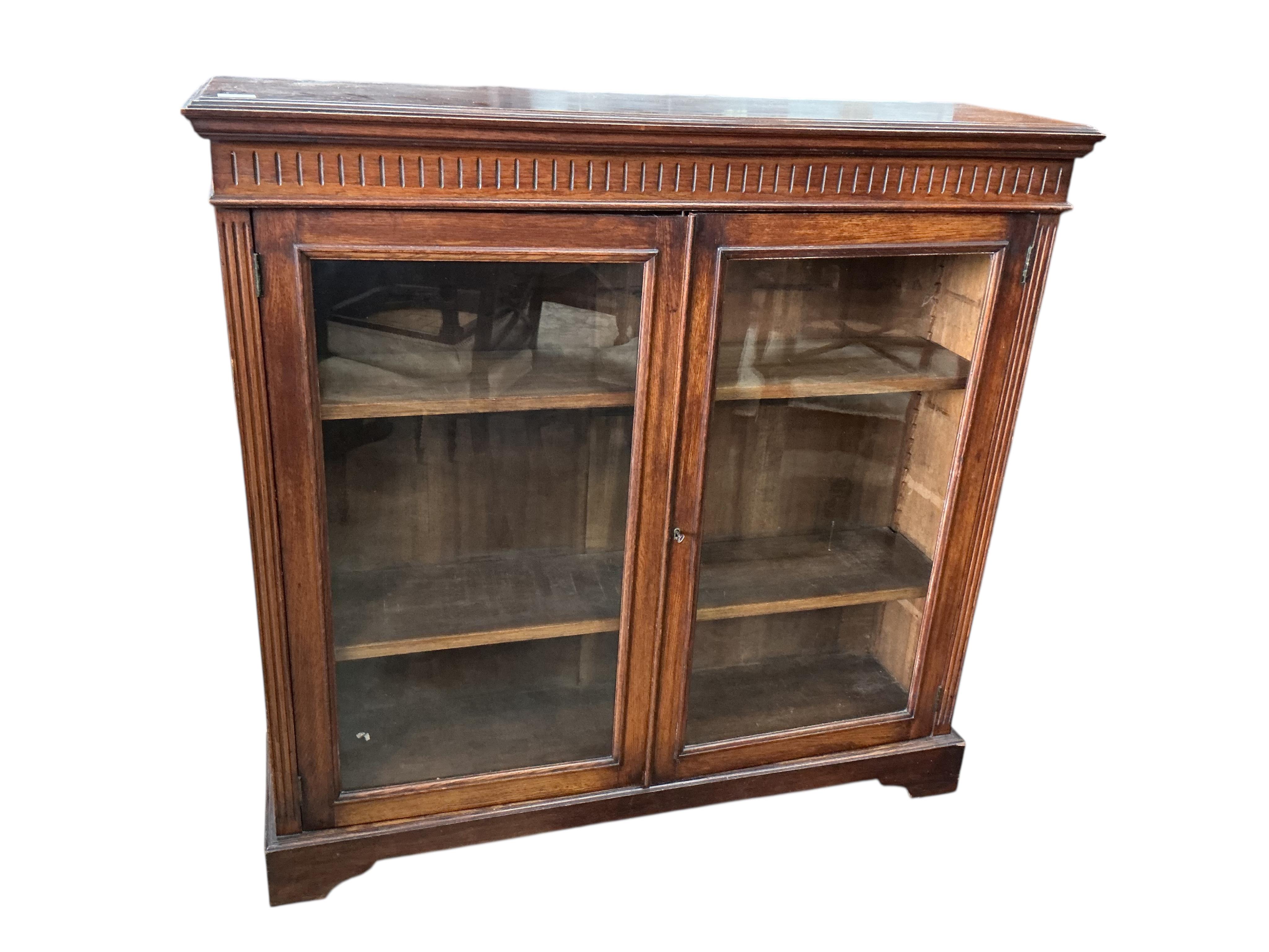 A late Victorian glazed oak bookcase, width 122cm, depth 33cm, height 118cm